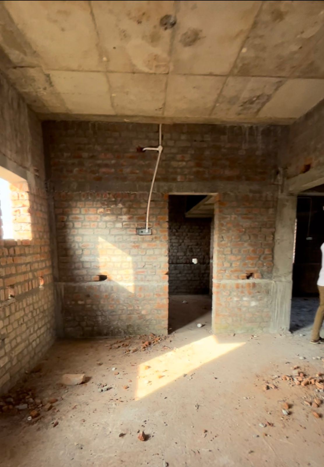 Bare brick interior walls with electrical conduit roughed in
